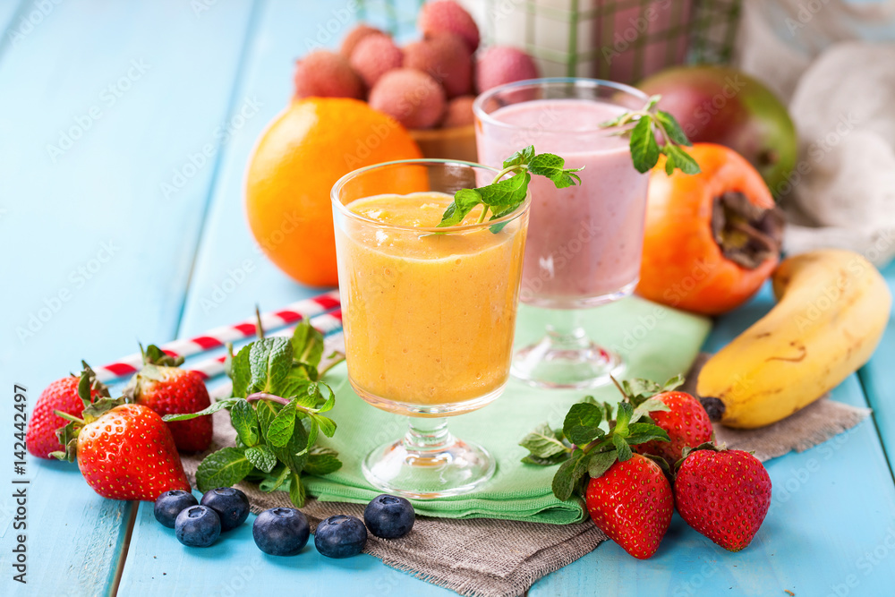 Orange persimmon blueberry smoothie and fruits. Selective focus. Copy space. Top view Orange persimmon blueberry smoothie and fruits. Selective focus. Copy space. Top view