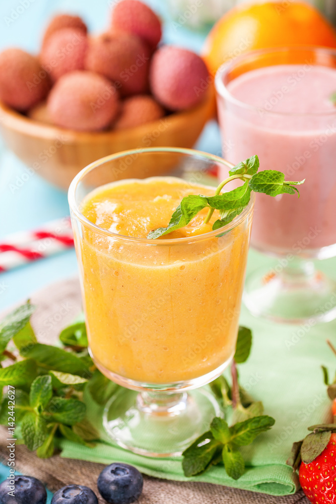 Orange persimmon blueberry smoothie and fruits. Selective focus. Copy space. Top view Orange persimmon blueberry smoothie and fruits. Selective focus. Copy space. Top view