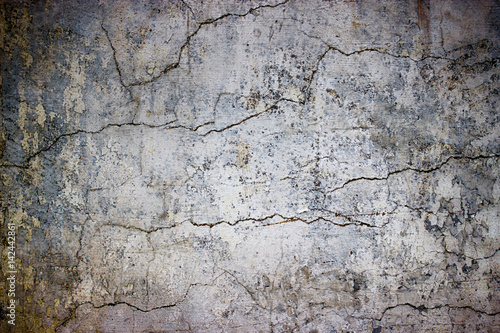 cracked concrete wall covered with gray cement texture as background for design