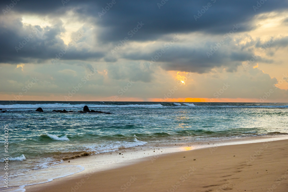 Sunset over the Indian ocean shore in Sri Lanka.