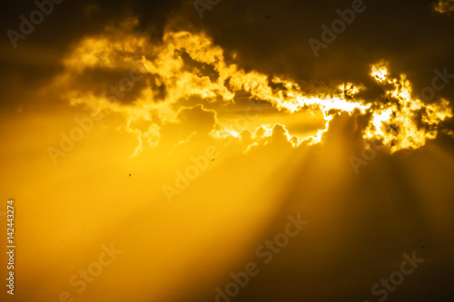 gloomy stormy sky with a glimpse of the sun and bright sun rays above the earth. Nature, landscape.