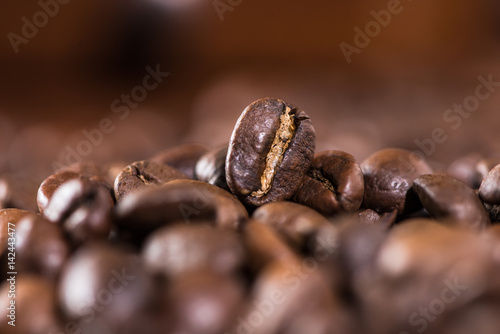 Brown aromatic coffee beans background, selective focus