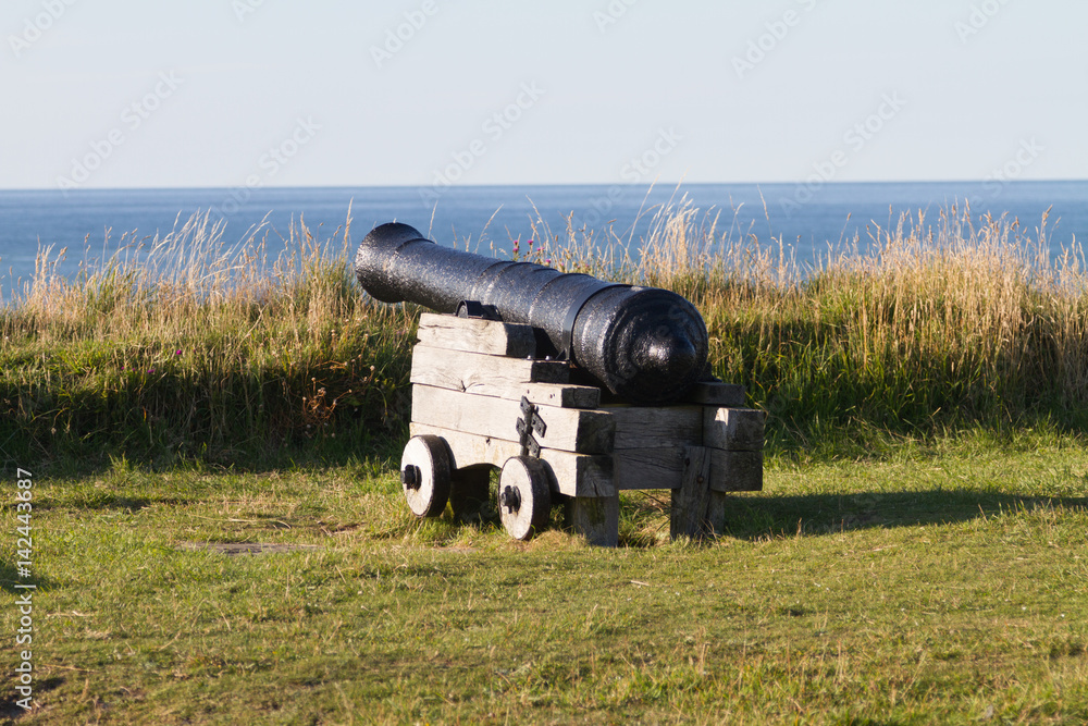 A black canon looks out to the sea in Fishguard, West Wales, United Kingdom