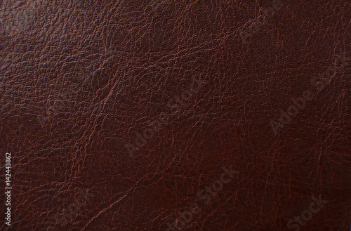 Dark red leather texture print as background.