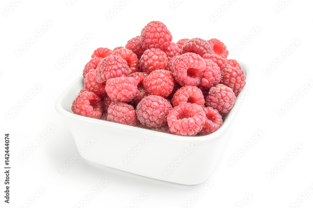 Raspberries on plate over white Raspberries on plate over white