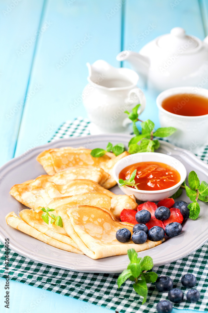 Pancakes with jam and berries on a table. Selective focus. Copy space. Pancakes with jam and berries on a table. Selective focus. Copy space.