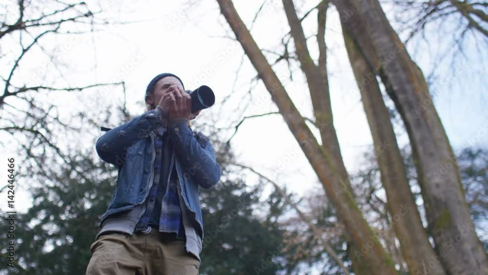 4K Low angle of photographer taking a photo in the forest 4K Low angle of photographer taking a photo in the forest