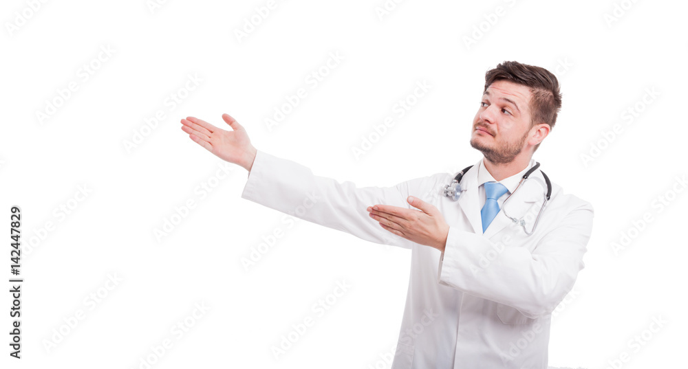 Handsome medic with stethoscope smiling and indicate something Handsome medic with stethoscope smiling and indicate something