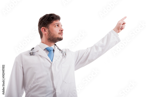 Serious medic or doctor pointing to something up