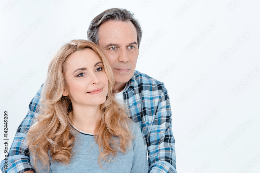 Front view of man and blonde woman embracing and smiling on white Front view of man and blonde woman embracing and smiling on white