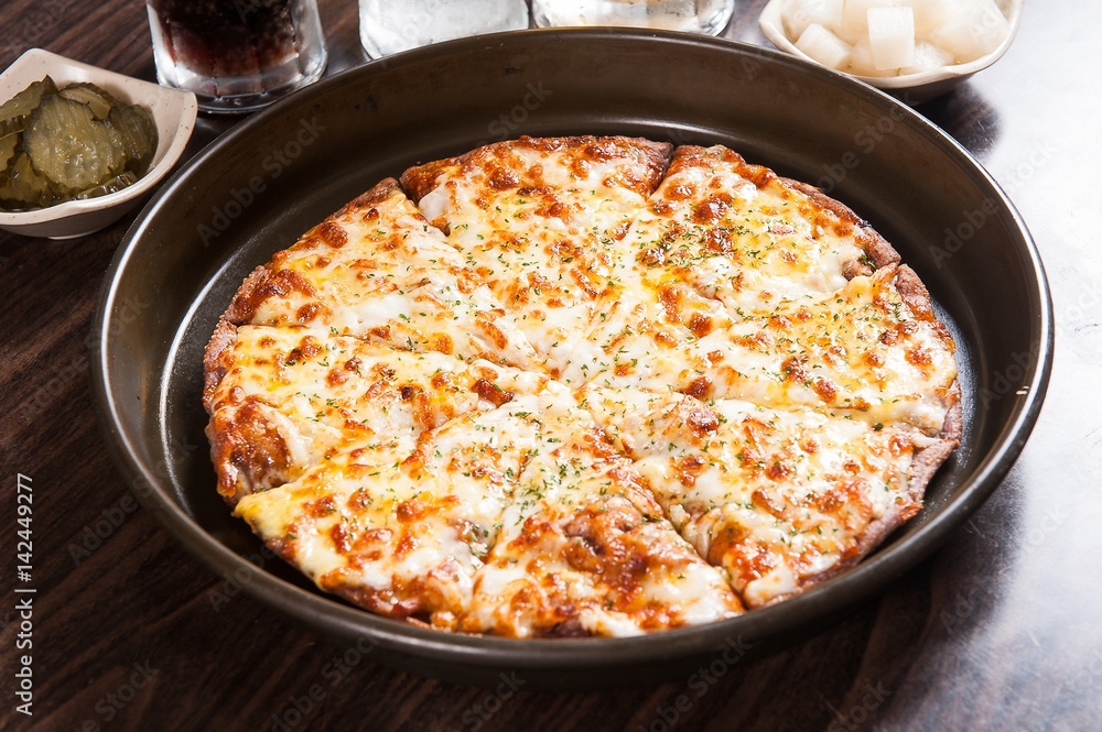 Cheese pizza on a wooden board Cheese pizza on a wooden board