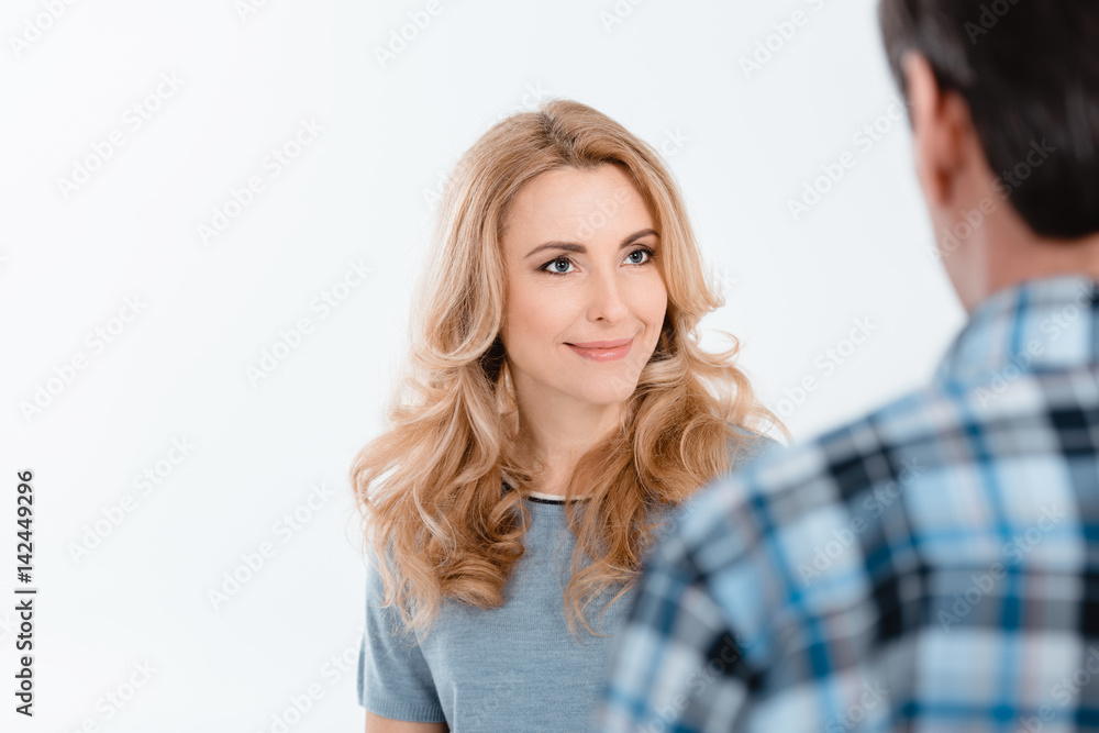 Portrait of attractive blonde woman looking on man on white Portrait of attractive blonde woman looking on man on white