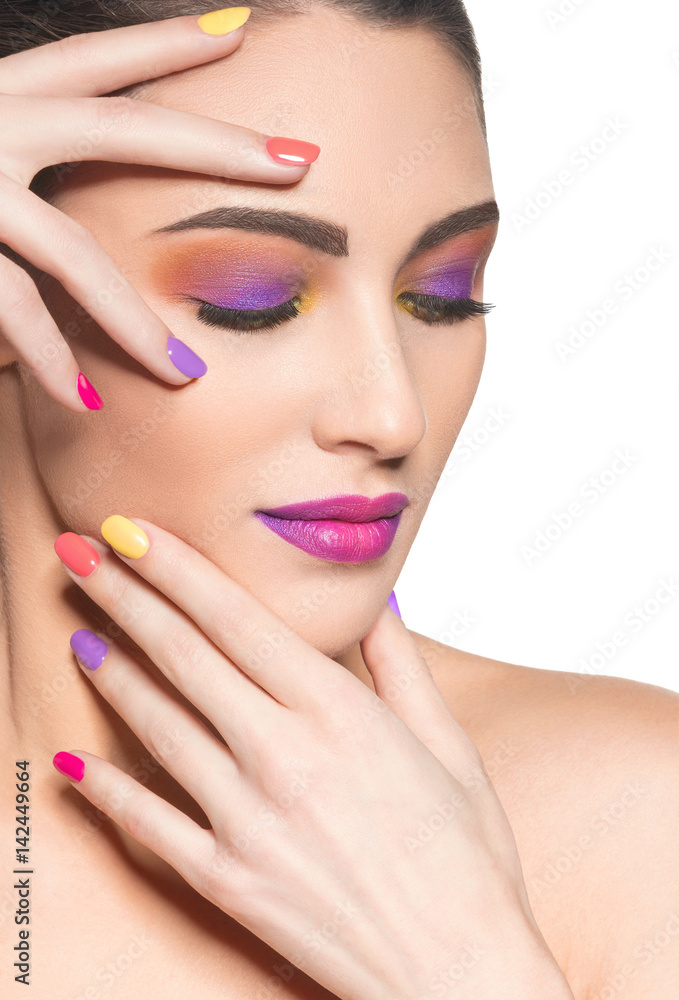 Fototapeta premium Beautiful woman with multicolor nails and fashion makeup
