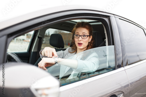 Attractive red hair businesswoman stuck in a traffic jam.She argue with other car drivers.Running late on job.