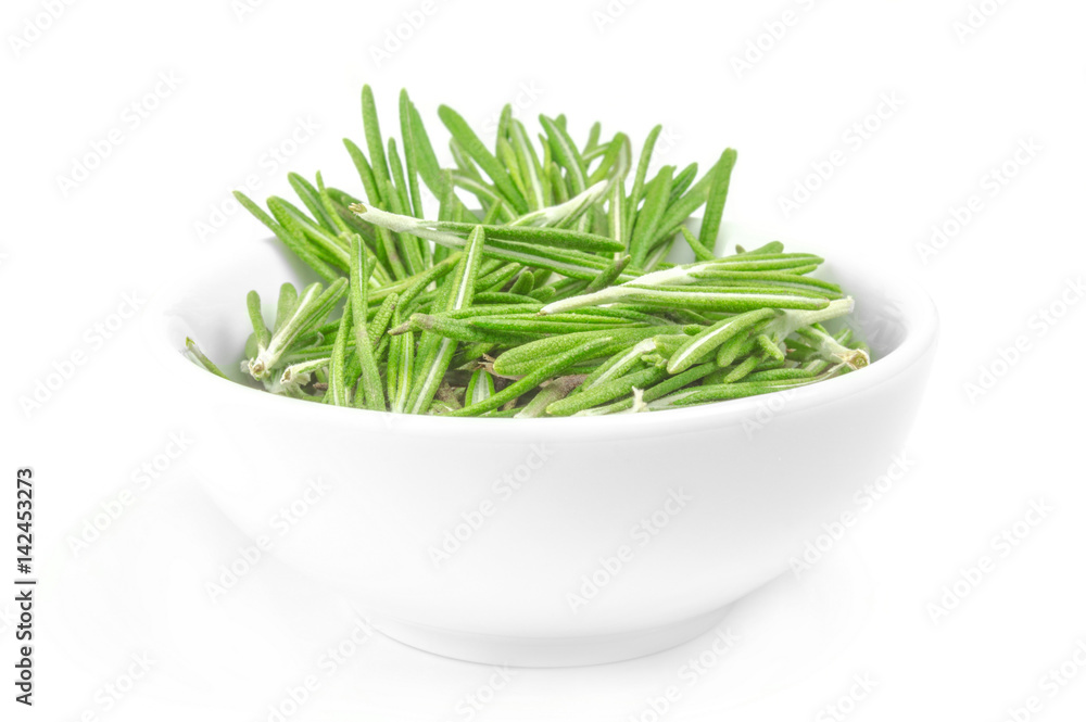 Fresh rosemary in a bowl on white background Fresh rosemary in a bowl on white background