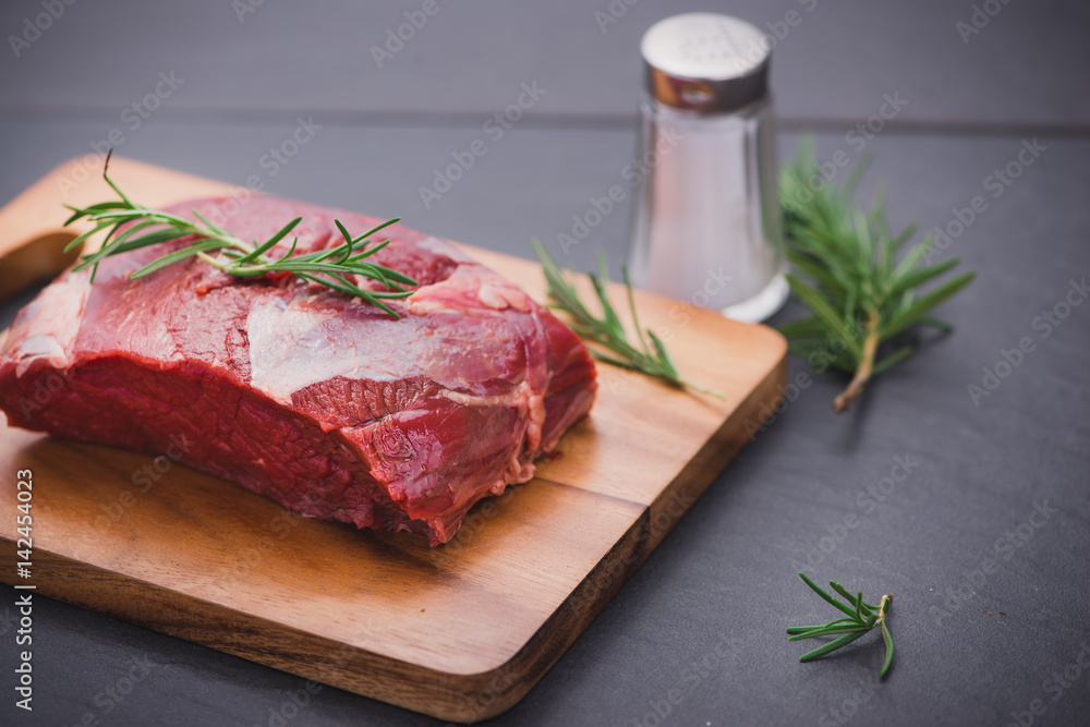 Raw beef meat on a cutting board Raw beef meat on a cutting board