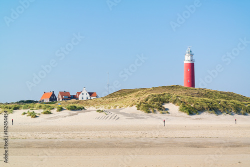 Beach and lighthouse De Cocksdorp, Texel, Netherlands photo
