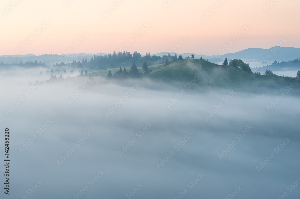 Fototapeta premium Foggy sunrise in the mountains