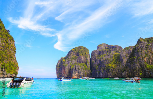 Thailand summer travel sea and beach, Thai old wood boat at sea beach Krabi Phi Phi Island Phuket park on white sand blue sky emerald green ocean water. space for texture