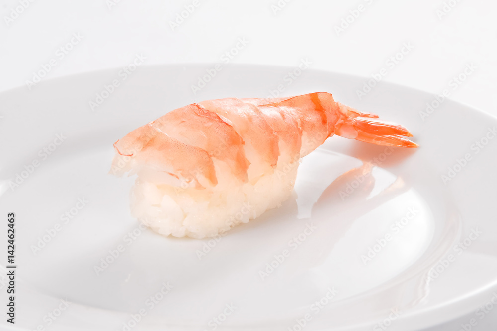 Sushi with tiger shrimp on a white plate on a white background. Sushi with tiger shrimp on a white plate on a white background.
