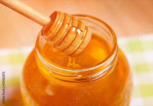 Honey on honeycomb background.