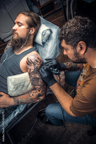 Tattoo specialist posing in tattoo studio