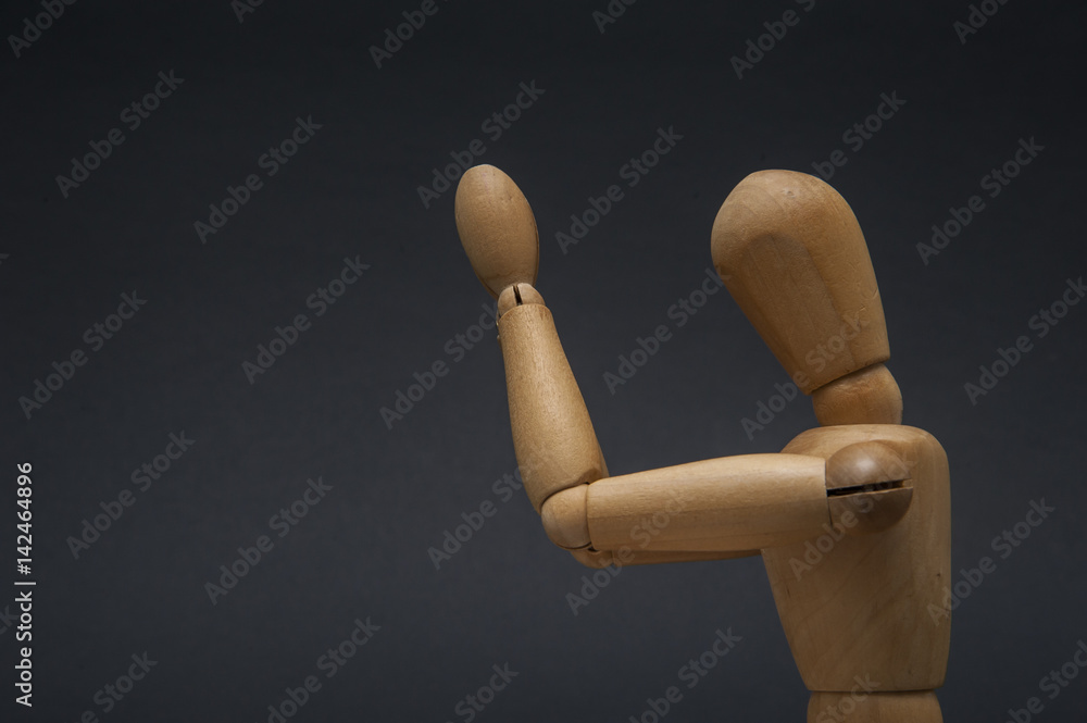 Wooden dummy representing a person holding his palms together in sacred prayer and his head tilted forward. Wooden dummy representing a person holding his palms together in sacred prayer and his head tilted forward.