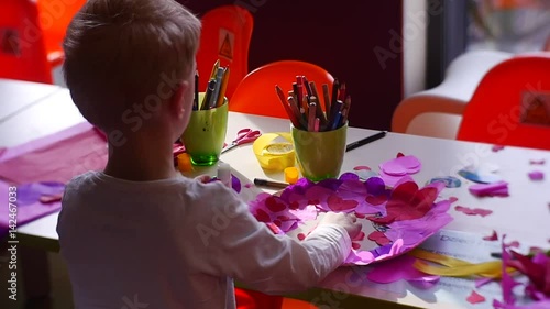 Boy Finishes Creation Beautiful Gift For Beloved photo