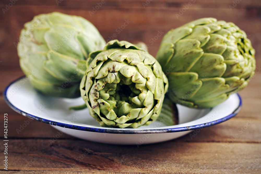Fototapeta premium Artichokes in a porcelain plate