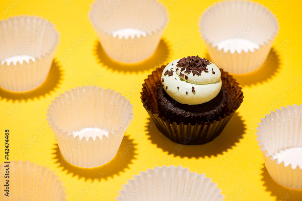 Birthday cupcake against a yellow background Birthday cupcake against a yellow background
