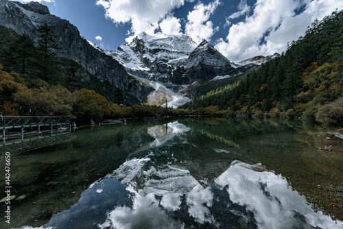 Mount Chenrizig and Pearl Lake in Daocheng,Sichuan,China. Mount Chenrizig is  one of the  three Tibetan holy mountians in Daocheng. photo