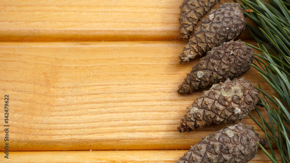 pine branches and cones on a wooden background pine branches and cones on a wooden background