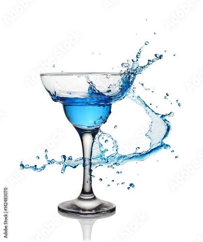 Splash in glass of a blue alcoholic cocktail drink