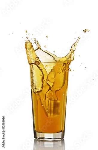 Splash in glass of orange juice with ice