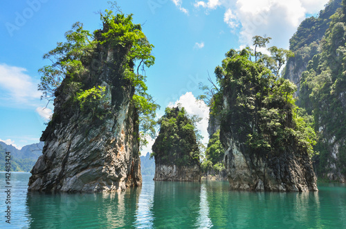Huge limestone cliffs rising out of open lake at Khao Sok National Park, Ratchaprapha Dam in Surat Thani Province, Thailand. © Kittichai