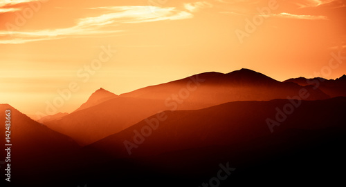 A beautiful, colorful, abstract mountain landscape in a red tonality. Decorative, artistic look.