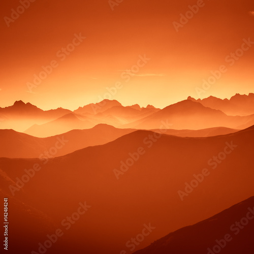 A beautiful, colorful, abstract mountain landscape in a red tonality. Decorative, artistic look. © dachux21