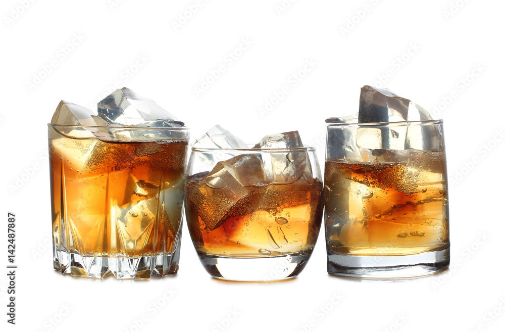 Whiskey and ice in glass on white background Whiskey and ice in glass on white background