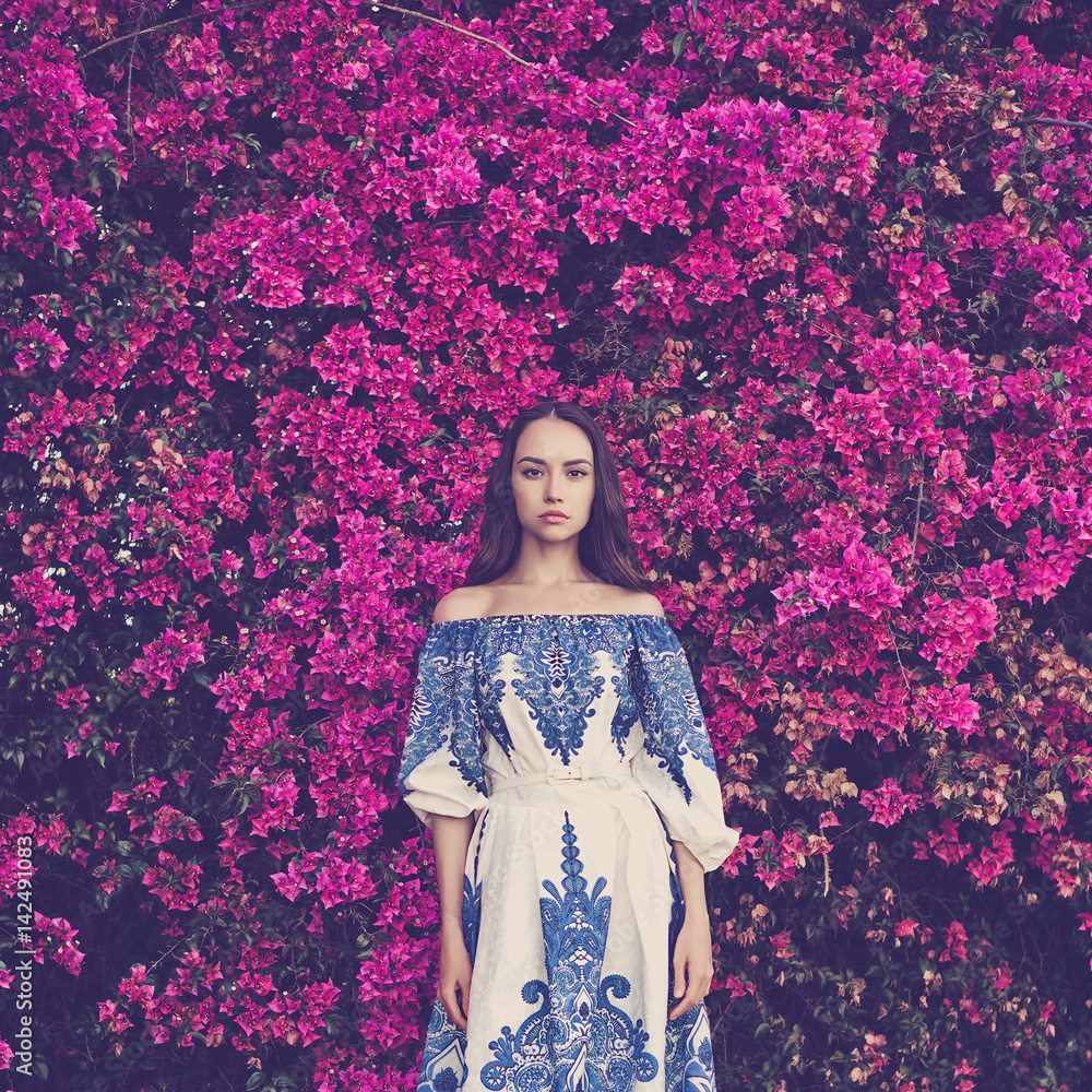 Beautiful young woman surrounded by flowers Beautiful young woman surrounded by flowers