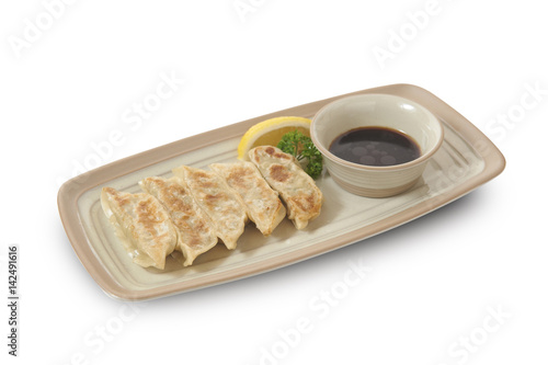 Isolated and clipping path of Japanese gyoza with soy sauce.