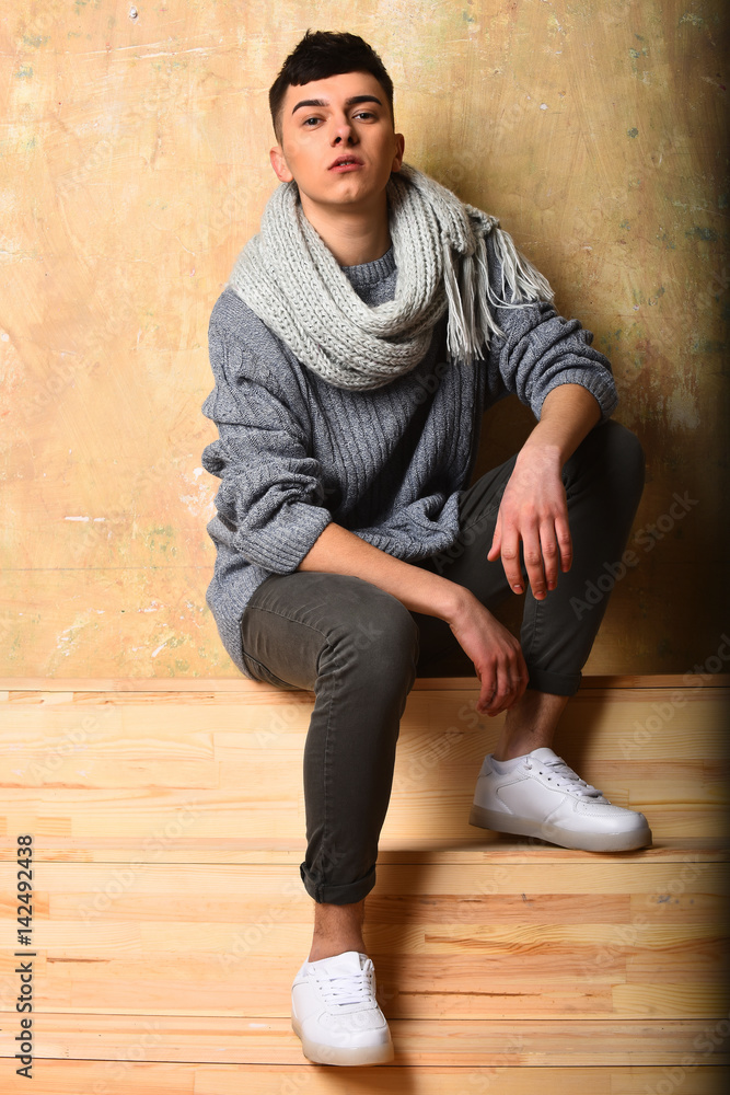 handsome young man in fashionable grey sweater and scarf handsome young man in fashionable grey sweater and scarf