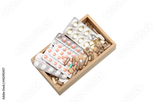 Set of pills and capsules in wooden box