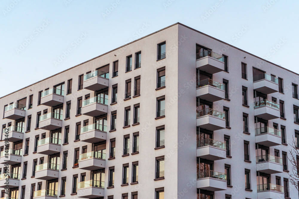 Fototapeta premium Corner of grey building with balconies
