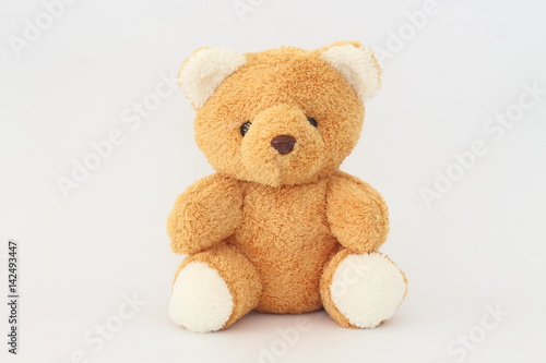 Teddy Bear looks cute on a white background.