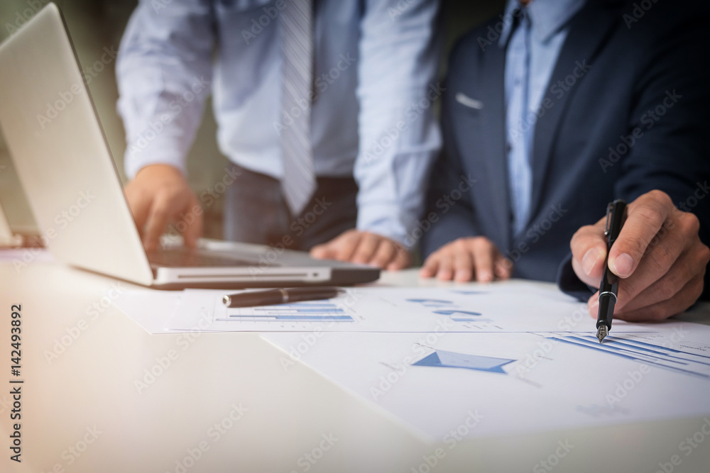 Teamwork process, Young businessmen hands pointing at document and laptop during explanation of new plan project data at meeting. Teamwork process, Young businessmen hands pointing at document and laptop during explanation of new plan project data at meeting.