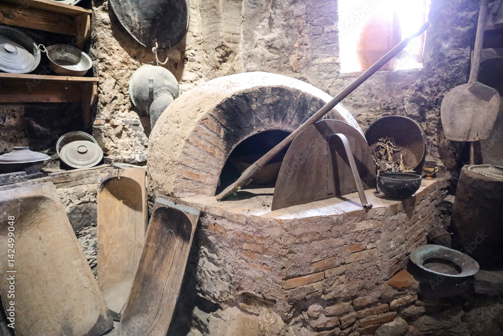Old oven next to kitchen utensils of the Great Meteoron Monastery.