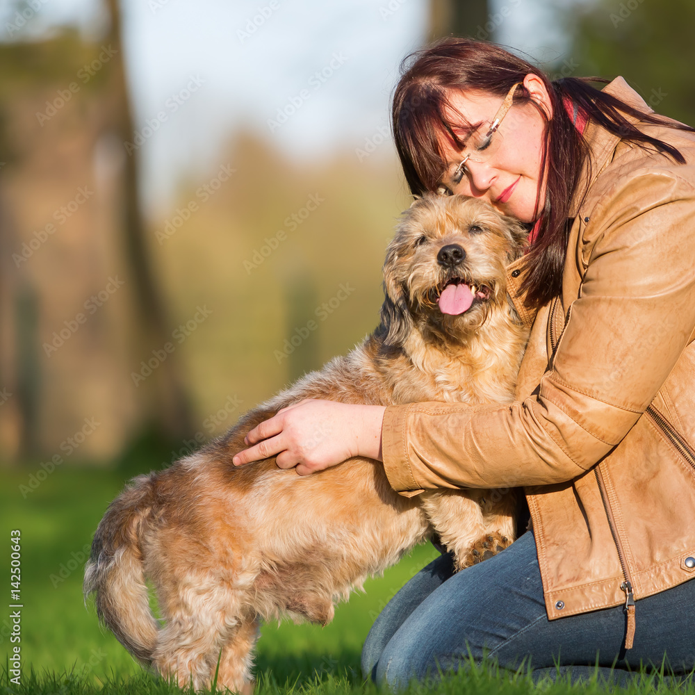 young woman cuddling with a cute dog young woman cuddling with a cute dog