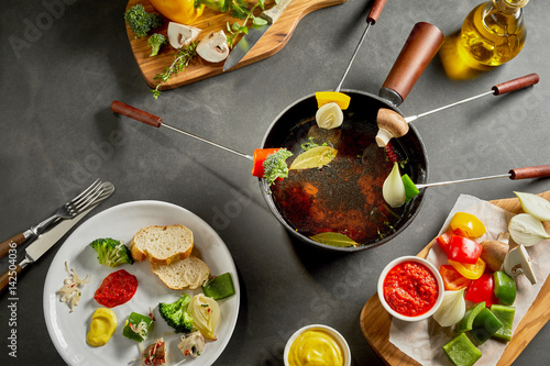 Eating a tasty fresh vegetable fondue photo