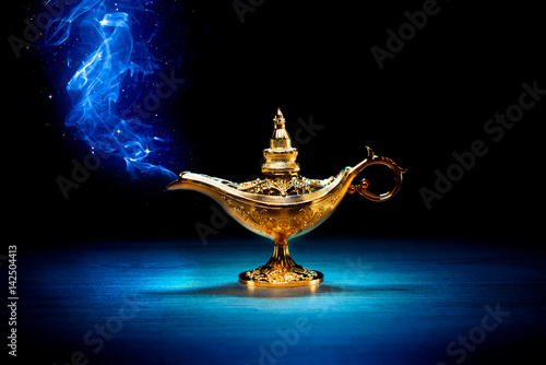 Foto Magic Aladdin / Genie lamp with smoke on a dark background