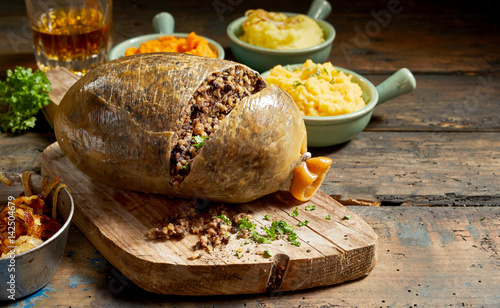 Bild auf Leinwand Cooked sliced open haggis and vegetables
